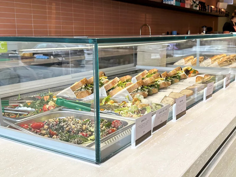 Self-service salad bar with various food options in a restaurant setting.
