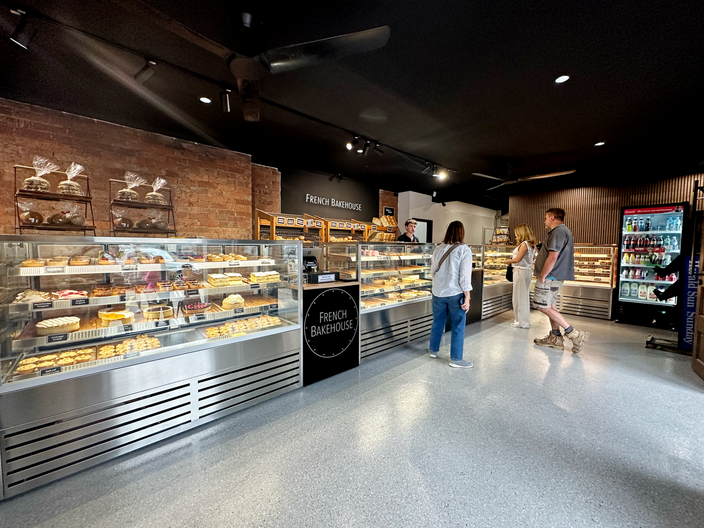 Bakery interior with display cases and people inside